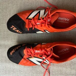 New Balance unisex SD100 v5 Black and Orange Athletic Shoes